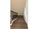 Carpeted staircase featuring a dark metal railing and light wooden handrail at 3402 Milan Ct, Douglasville, GA 30135