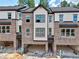 Modern townhome with brick facade, attached garages, and neutral-toned siding at 6 Rock Park Way # 15, Tucker, GA 30084