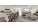 Open floor plan features a kitchen that opens to the living room with neutral colors and furniture at 2289 Argento Cir, Dacula, GA 30019