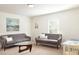 Bright living room with modern gray sofas, a unique glass coffee table, and tasteful decor at 2289 Argento Cir, Dacula, GA 30019