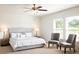Inviting main bedroom with a tufted headboard, soft bedding, and a ceiling fan at 2289 Argento Cir, Dacula, GA 30019