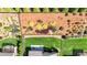 Aerial view showcasing backyard oasis with pristine lawn, verdant landscaping, and peaceful patio area at 5640 Hammock Way, Cumming, GA 30028