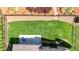 Aerial view of a spacious backyard featuring a pristine lawn, lush landscaping, and private patio at 5640 Hammock Way, Cumming, GA 30028