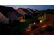 Night view of a backyard with professional landscaping and manicured lawn and patio with covered porch at 5640 Hammock Way, Cumming, GA 30028