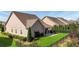 Exterior backyard featuring a well-manicured lawn, fenced border, and covered patio perfect for entertaining at 5640 Hammock Way, Cumming, GA 30028