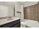 Well-lit bathroom with a granite vanity and tile-surround shower/tub combo, offering a blend of style and functionality at 5640 Hammock Way, Cumming, GA 30028