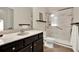 Bathroom featuring a large vanity, granite countertops, a seamless glass door shower, and tile flooring at 5640 Hammock Way, Cumming, GA 30028
