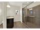 Bathroom with a large shower featuring tiled walls, glass door, and grab bars at 5640 Hammock Way, Cumming, GA 30028