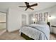 Bedroom features a plush bed, neutral decor, and a large window at 5640 Hammock Way, Cumming, GA 30028