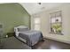 Bedroom featuring vaulted ceilings, two windows and a cozy bed with dark hardwood floors at 5640 Hammock Way, Cumming, GA 30028