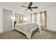 Bedroom features a plush bed, neutral decor, and a large window at 5640 Hammock Way, Cumming, GA 30028