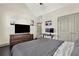 Bedroom with vaulted ceilings and dark hardwood floors, with furniture and gray bedspread at 5640 Hammock Way, Cumming, GA 30028