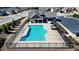 Stunning aerial view of the community pool, with lounge chairs and a cabana at 5640 Hammock Way, Cumming, GA 30028