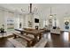Dining room features an elegant chandelier, dining table, fireplace, and abundant natural light at 5640 Hammock Way, Cumming, GA 30028