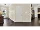 Lovely home entryway featuring dark hardwood floors and neutral walls with an adjacent exterior door at 5640 Hammock Way, Cumming, GA 30028