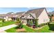 Well-maintained home exterior with lush green lawn and manicured landscaping at 5640 Hammock Way, Cumming, GA 30028