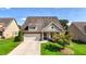 Charming single-Gathering home with well-manicured lawn, two car garage, and inviting curb appeal at 5640 Hammock Way, Cumming, GA 30028
