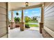 Charming front porch with brick columns and space for seating and plants to add curb appeal at 5640 Hammock Way, Cumming, GA 30028