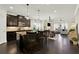 Spacious kitchen with dark wood floors, dark cabinetry, granite countertops and a large island at 5640 Hammock Way, Cumming, GA 30028