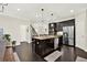 Open concept kitchen with a center island, stainless steel appliances and dark cabinetry at 5640 Hammock Way, Cumming, GA 30028