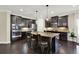 Gourmet kitchen featuring stainless steel appliances, granite countertops and dark cabinetry at 5640 Hammock Way, Cumming, GA 30028