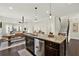 Open concept kitchen with a center island and stainless steel appliances with an attached dining area at 5640 Hammock Way, Cumming, GA 30028