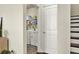 Bright laundry room with modern washer and dryer and shelving for storage at 5640 Hammock Way, Cumming, GA 30028