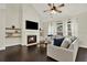 Comfortable living room showcasing a fireplace, vaulted ceiling, and dark hardwood flooring at 5640 Hammock Way, Cumming, GA 30028