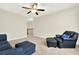 Cozy upstairs living room with plush seating, ceiling fan, and natural light ideal for unwinding and spending time at 5640 Hammock Way, Cumming, GA 30028