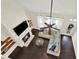 Bright living room featuring fireplace, soaring ceilings, wood floors, and large windows for a modern, airy feel at 5640 Hammock Way, Cumming, GA 30028