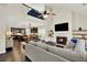 Open-concept living space with fireplace, hardwood floors, and view to kitchen and upstairs loft area at 5640 Hammock Way, Cumming, GA 30028