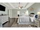 Bright main bedroom with trey ceiling, fan, hardwood flooring, and abundant natural light at 5640 Hammock Way, Cumming, GA 30028