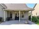 Covered patio featuring ceiling fans, outdoor seating, and a view of the backyard at 5640 Hammock Way, Cumming, GA 30028