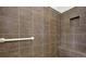Close up on the shower features tiled walls, a bench, and a niche at 5640 Hammock Way, Cumming, GA 30028