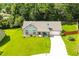 A well manicured lawn and single story home surrounded by lush trees at 787 Mckendree Lake Way, Lawrenceville, GA 30043