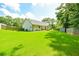 Lush backyard with a well-manicured lawn, wooden fence, and mature trees for privacy at 787 Mckendree Lake Way, Lawrenceville, GA 30043