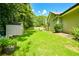 Large grassy backyard with a storage shed, bordered by trees and lush greenery, providing a private retreat at 787 Mckendree Lake Way, Lawrenceville, GA 30043