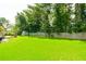 Spacious backyard with a well-kept lawn, shed, and wooded perimeter offering serene privacy at 787 Mckendree Lake Way, Lawrenceville, GA 30043