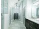 Bathroom with a double sink vanity, modern fixtures, and a glass-enclosed shower for a spa-like experience at 787 Mckendree Lake Way, Lawrenceville, GA 30043