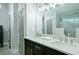 Bathroom featuring a double sink vanity with modern fixtures, and a glass-enclosed shower with a seat at 787 Mckendree Lake Way, Lawrenceville, GA 30043