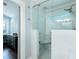 Modern glass shower includes a rain shower head with bench seating that is accessible from the main bedroom at 787 Mckendree Lake Way, Lawrenceville, GA 30043