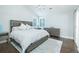 Bright bedroom showcasing a comfy bed, modern dresser, and great natural lighting through big windows at 787 Mckendree Lake Way, Lawrenceville, GA 30043