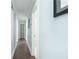 Long hallway features hardwood floors and light gray walls in this beautifully styled home at 787 Mckendree Lake Way, Lawrenceville, GA 30043