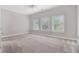 A sunlit bedroom with plush carpet, ceiling fan, and multiple windows offering pleasant views at 1836 Preserve Way, Brookhaven, GA 30341