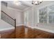 Bright dining room featuring hardwood floors, large windows, a chandelier and stairs at 1836 Preserve Way, Brookhaven, GA 30341
