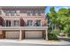 Brick townhome featuring private balconies, attached garages, and manicured landscaping at 1836 Preserve Way, Brookhaven, GA 30341