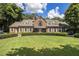 Sprawling brick home with manicured lawn, symmetrical design, and elegant shuttered windows at 1836 Preserve Way, Brookhaven, GA 30341