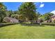 Expansive green lawn with mature trees and manicured hedges creating a serene community space at 1836 Preserve Way, Brookhaven, GA 30341