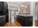 Open concept kitchen with dark cabinets, granite countertops, stainless steel appliances, and hardwood floors at 1836 Preserve Way, Brookhaven, GA 30341