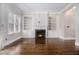 Inviting living room featuring hardwood floors, a fireplace, and built-in bookcases flanking a window at 1836 Preserve Way, Brookhaven, GA 30341